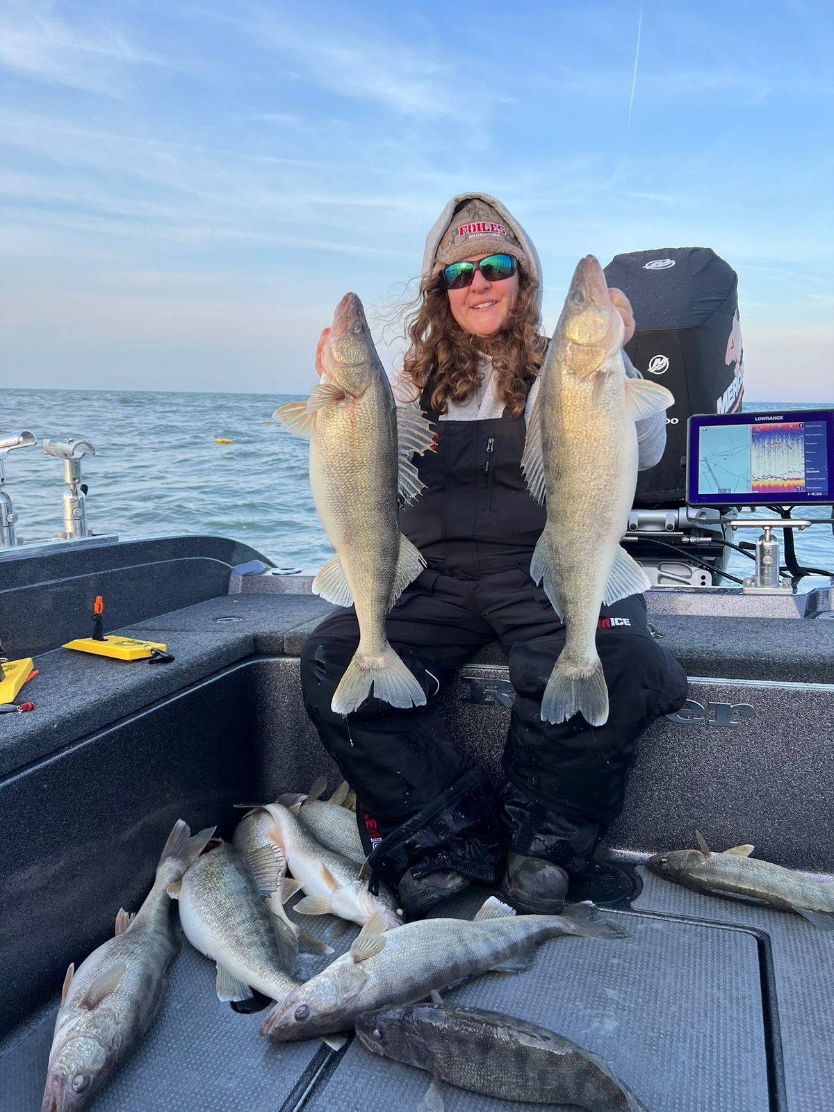 Megan holds up a nice batch of Lake Erie walleye from a Huckeye Charters walleye charter