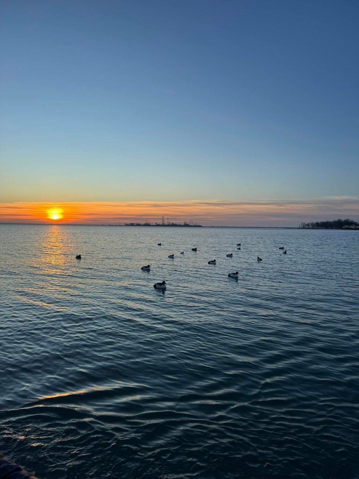 Sunrise over Lake Erie with a Huckeye Charters decoy spread on the water before a morning waterfowl hunt