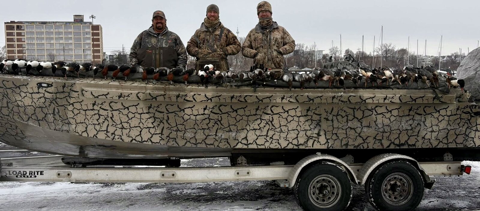 Hunt 41 collector hunters posed with trophy-quality drakes including Red-Breasted Merganser, Bufflehead, and Goldeneye on Lake Erie