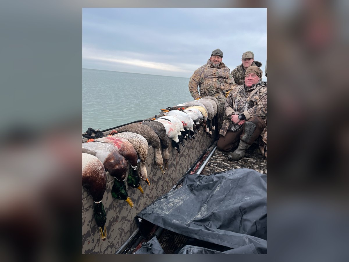 Three Huckeye Charters hunters with a boat full of Lake Erie ducks after a standard waterfowl hunt