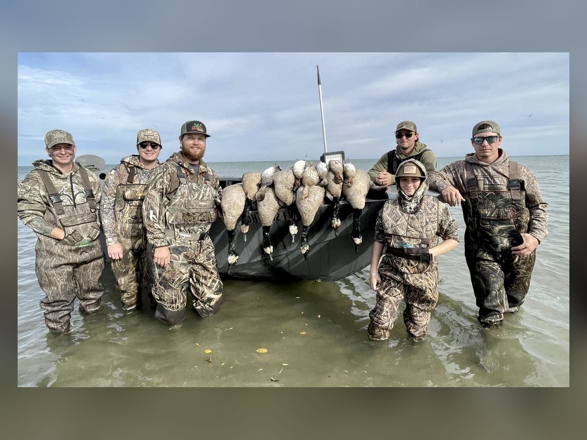 A group of hunters, including a young hunter, with a limit of Lake Erie Canada geese